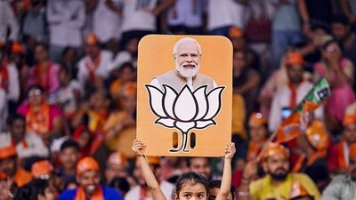 Stock market after Lok Sabha elections: A child holds a placard depicting PM Modi and BJP election symbol during a public meeting addressed by Uttar Pradesh Chief Minister Yogi Adityanath for Lok Sabha polls, in Varanasi. (PTI) Stock market after Lok Sabha elections: A child holds a placard depicting PM Modi and BJP election symbol during a public meeting addressed by Uttar Pradesh Chief Minister Yogi Adityanath for Lok Sabha polls, in Varanasi. (PTI)