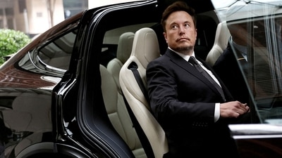 Tesla layoffs: Tesla Chief Executive Officer Elon Musk gets in a Tesla car as he leaves a hotel in Beijing, China. (Reuters)