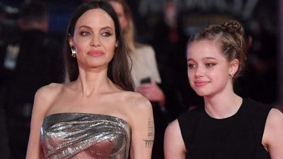 Angelina Jolie dresses up in silver bodycon gown with Shiloh for Eternals premiere (AFP)