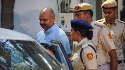 Delhi Police personnel with Chief Minister Arvind Kejriwal's aide Bibhav Kumar. (PTI) Delhi Police personnel with Chief Minister Arvind Kejriwal's aide Bibhav Kumar. (PTI)