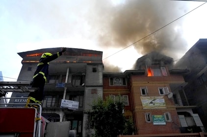 Srinagar: Fire and Emergency Services personnel try to douse a fire that erupted in a commercial building, at Raj Bagh (PTI) Srinagar: Fire and Emergency Services personnel try to douse a fire that erupted in a commercial building, at Raj Bagh (PTI)