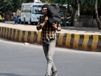 Noida, India- May 27, 2024: Commuters seen with their heads covered to protect them from the hot summer day at sector 38.The India Meteorological Department (IMD) on Sunday said that Delhi-NCR will continue experiencing a "severe heatwave" for the next three days and has issued a red alert in the area until May 29, in Noida, India, on Monday, May 27, 2024. (Photo by Sunil Ghosh / Hindustan Times) Noida, India- May 27, 2024: Commuters seen with their heads covered to protect them from the hot summer day at sector 38.The India Meteorological Department (IMD) on Sunday said that Delhi-NCR will continue experiencing a "severe heatwave" for the next three days and has issued a red alert in the area until May 29, in Noida, India, on Monday, May 27, 2024. (Photo by Sunil Ghosh / Hindustan Times)