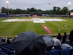 England vs Pakistan: Spectators sit with umbrellas in the stand as rain plays spoilsport in Cardiff