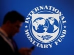 &nbsp;A participant stands near a logo of IMF at the International Monetary Fund - World Bank annual meeting &nbsp;in Nusa Dua, Bali, Indonesia.