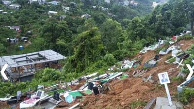 A view of graves after being swept away in a landslide, amid heavy rain in the aftermath of Cyclone Remal in Mizoram’s Aizawl district, on Wednesday. (PTI) A view of graves after being swept away in a landslide, amid heavy rain in the aftermath of Cyclone Remal in Mizoram’s Aizawl district, on Wednesday. (PTI)