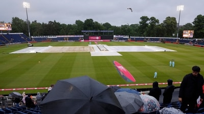 England vs Pakistan: Spectators sit with umbrellas in the stand as rain plays spoilsport in Cardiff (Action Images via Reuters)
