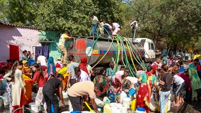 People collect drinking water from a tanker on a hot summer day at Vivekanand camp in New Delhi on May 28. (PTI) People collect drinking water from a tanker on a hot summer day at Vivekanand camp in New Delhi on May 28. (PTI)