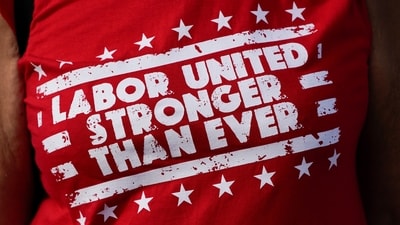 FILE - A United Auto Workers member wears a t-shirt while walking in the Labor Day parade in Detroit. (AP Photo/Paul Sancya, File) (AP) FILE - A United Auto Workers member wears a t-shirt while walking in the Labor Day parade in Detroit. (AP Photo/Paul Sancya, File) (AP)