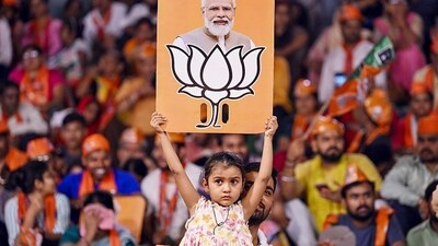 Stock market after Lok Sabha elections: A child holds a placard depicting PM Modi and BJP election symbol during a public meeting addressed by Uttar Pradesh Chief Minister Yogi Adityanath for Lok Sabha polls, in Varanasi. (PTI) Stock market after Lok Sabha elections: A child holds a placard depicting PM Modi and BJP election symbol during a public meeting addressed by Uttar Pradesh Chief Minister Yogi Adityanath for Lok Sabha polls, in Varanasi. (PTI)