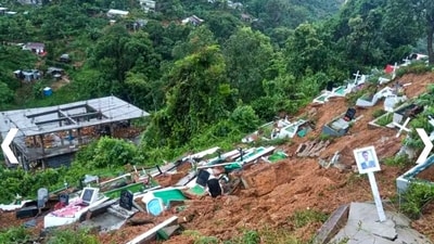 Aizawl: View of graves after being swept away in a landslide, amid heavy rain in the aftermath of Cyclone Remal, in Aizawl district, Wednesday, May 29, 2024. The death toll in multiple landslides in the district mounted to 29 after four more bodies were recovered from various places, a police officer said on Wednesday. (PTI Photo) (PTI05_29_2024_000252B) (PTI) Aizawl: View of graves after being swept away in a landslide, amid heavy rain in the aftermath of Cyclone Remal, in Aizawl district, Wednesday, May 29, 2024. The death toll in multiple landslides in the district mounted to 29 after four more bodies were recovered from various places, a police officer said on Wednesday. (PTI Photo) (PTI05_29_2024_000252B) (PTI)
