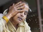 A woman splashes water on her face on a hot summer day amid a searing heatwave in Delhi on Wednesday. (PTI Photo)(HT_PRINT)