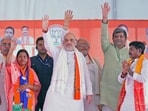 Union Home Minister Amit Shah greets people during a public meeting for the last phase of Lok Sabha polls, in Robertsganj on Wednesday.