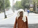 An elderly person out on the streets on a sultry summer day in Mungeshpur, Delhi. (HT Photo)