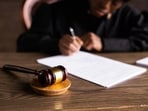 The man who appeared in his court hearing online while driving a car with a suspended licence spent two days in custody. The man who appeared in his court hearing online while driving a car with a suspended licence spent two days in custody.