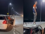 Mumbai: The image, taken from the viral video, shows the man coming out of the car and standing atop its roof. Mumbai: The image, taken from the viral video, shows the man coming out of the car and standing atop its roof.