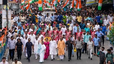 West Bengal Chief Minister Mamata Banerjee walks with party supporters during a road show in Kolkata, West Bengal. (AP) West Bengal Chief Minister Mamata Banerjee walks with party supporters during a road show in Kolkata, West Bengal. (AP)