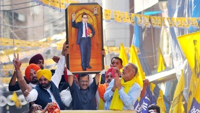 Delhi Chief Minister and Aam Aadmi Party (AAP) National Convener Arvind Kejriwal holds up a portrait of Dr. BR Ambedkar along with Punjab CM Bhagwant Mann during a roadshow in Patiala, Punjab. (ANI) Delhi Chief Minister and Aam Aadmi Party (AAP) National Convener Arvind Kejriwal holds up a portrait of Dr. BR Ambedkar along with Punjab CM Bhagwant Mann during a roadshow in Patiala, Punjab. (ANI)