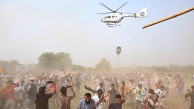 People run as helicopter carrying BJP candidate Ravi Shankar Prasad and National President of Lok Janshakti Party (Ram Vilas) Chirag Paswan takes off after a public meeting at Khusrupur, in Patna. (PTI) People run as helicopter carrying BJP candidate Ravi Shankar Prasad and National President of Lok Janshakti Party (Ram Vilas) Chirag Paswan takes off after a public meeting at Khusrupur, in Patna. (PTI)