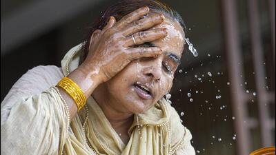 A woman splashes water on her face on a hot summer day amid a searing heatwave in Delhi on Wednesday. (PTI Photo) A woman splashes water on her face on a hot summer day amid a searing heatwave in Delhi on Wednesday. (PTI Photo)
