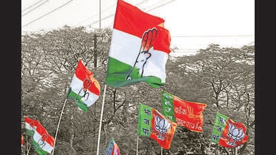 Congress and BJP supporters wave flags in a show of strength in Indore India (HT File)
