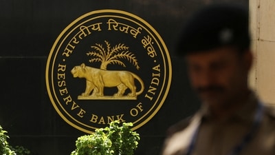 A police officer walks past the Reserve Bank of India (RBI) logo inside its headquarters in Mumbai, India. (Reuters)