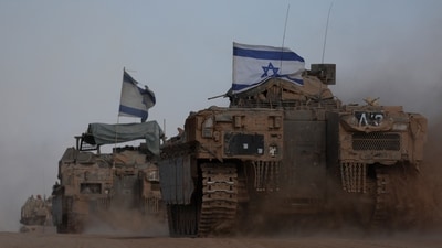Israeli armoured personnel carriers (APC) operate, amid the ongoing conflict between Israel and the Palestinian Islamist group Hamas, near Israel's border with Gaza in southern Israel (REUTERS)
