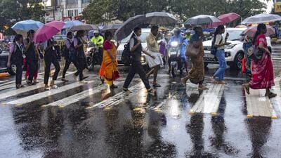 Kochi: Pedestrians hold umbrellas as they cross a street amid rains, in Kochi, Wednesday, May 29, 2024. India Meteorological Department (IMD) has forecasted very heavy rainfall in five districts of Kerala in the coming hours. (PTI Photo) (PTI05_29_2024_000231A) (PTI) Kochi: Pedestrians hold umbrellas as they cross a street amid rains, in Kochi, Wednesday, May 29, 2024. India Meteorological Department (IMD) has forecasted very heavy rainfall in five districts of Kerala in the coming hours. (PTI Photo) (PTI05_29_2024_000231A) (PTI)