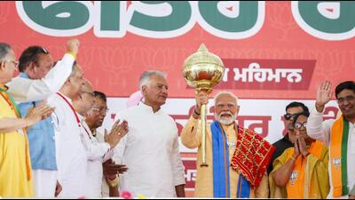 Prime Minister Narendra Modi holding up a mace at a public meeting in Hoshiarpur on Thursday, the last day for campaigning for the last phase of the Lok Sabha elections. (PTI Photo) Prime Minister Narendra Modi holding up a mace at a public meeting in Hoshiarpur on Thursday, the last day for campaigning for the last phase of the Lok Sabha elections. (PTI Photo)