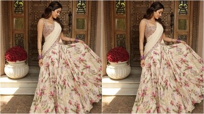 She paired it with a floral lehenga skirt with an enchanting floral print in shades of pink and green. She teamed it with an ivory dupatta with a matching floral border. She draped it around her in a traditional manner, which perfectly complemented her ethnic attire. (Instagram/@stylebyami) She paired it with a floral lehenga skirt with an enchanting floral print in shades of pink and green. She teamed it with an ivory dupatta with a matching floral border. She draped it around her in a traditional manner, which perfectly complemented her ethnic attire. (Instagram/@stylebyami)