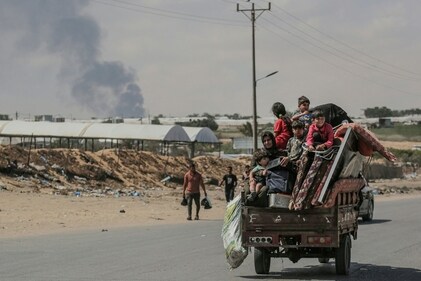 Palestinians fleeing with their belongings ride atop their vehicle in Rafah in the southern Gaza Strip on May 29, 2024, amid the ongoing conflict between Israel and the Palestinian Hamas militant group. (AFP) Palestinians fleeing with their belongings ride atop their vehicle in Rafah in the southern Gaza Strip on May 29, 2024, amid the ongoing conflict between Israel and the Palestinian Hamas militant group. (AFP)