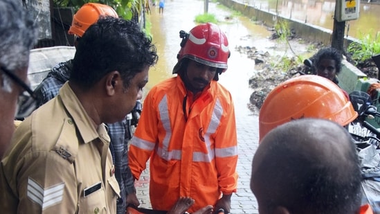 Kerala Fire and Rescue Services personnel evacuated an elderly woman from a flood-hit area in Thiruvananthapuram on Wednesday, May 29, 2024, following heavy rainfall. The capital city experienced severe waterlogging and disruptions to normal life.(PTI)