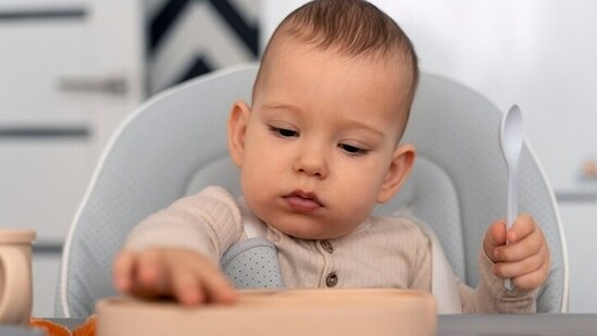 ICMR guidelines say that infant's act of spitting out the semi-solid food could be part of their learning process to swallow the food and it doesn't mean they dislike the food. (Freepik)