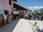 Voters queue up at a polling booth in Srinagar.