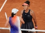 Poland's Iga Swiatek (L) cheers Japan's Naomi Osaka after winning their women's singles match on Court Philippe-Chatrier on day four of the French Open tennis tournament at the Roland Garros Complex in Paris on May 29