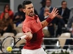 Serbia's Novak Djokovic plays a forehand return.