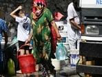 Residents fill containers with water supplied by a municipal tanker in New Delhi amid ongoing heatwave. Residents fill containers with water supplied by a municipal tanker in New Delhi amid ongoing heatwave.
