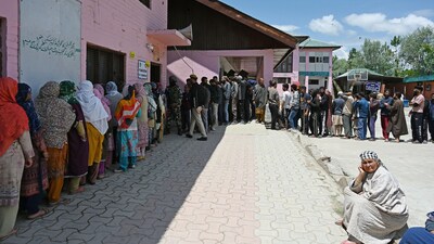 Voters queue up at a polling booth in Srinagar.
