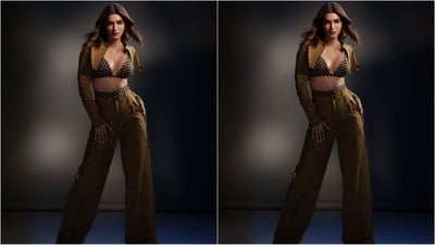 Her outfit consisted of a camel coloured cropped jacket with a bold metal zip fly down the middle, full sleeves and a mandarin collar. She paired it with a blue and camel plaid bralette with a deep v-neckline, thin shoulder straps and a tie fastening at the back. She finished off her chic look with matching high-waisted straight leg trousers. (Instagram/@kritisanon) Her outfit consisted of a camel coloured cropped jacket with a bold metal zip fly down the middle, full sleeves and a mandarin collar. She paired it with a blue and camel plaid bralette with a deep v-neckline, thin shoulder straps and a tie fastening at the back. She finished off her chic look with matching high-waisted straight leg trousers. (Instagram/@kritisanon)