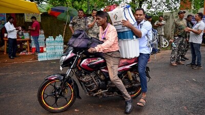 Polling officials carrying EVMs and other polling materials on bike leave for their respective polling booths in Dumka, Jharkhand. (ANI) Polling officials carrying EVMs and other polling materials on bike leave for their respective polling booths in Dumka, Jharkhand. (ANI)