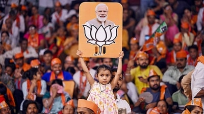 A child holds a placard depicting PM Modi and the BJP election symbol during a public meeting in Uttar Pradesh. (PTI Photo) A child holds a placard depicting PM Modi and the BJP election symbol during a public meeting in Uttar Pradesh. (PTI Photo)