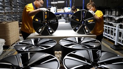 Workers labor in a factory of automotive aluminium wheel hubs in Binzhou city in east China's Shandong province. (AP)