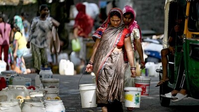 Residents carry water containers after filling them from a municipal tanker in a low-income neighbourhood in New Delhi (AFP) Residents carry water containers after filling them from a municipal tanker in a low-income neighbourhood in New Delhi (AFP)