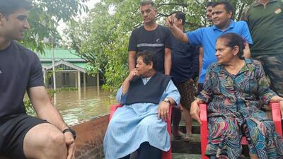 Manipur Governor Anusuiya Uikey inspecting flooding in and around Raj Bhawan in Imphal on a raft on Friday (HT Photo)