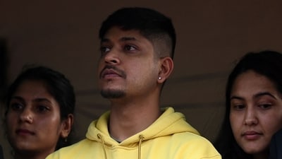 Sandeep Lamichhane looks on outside Patan High Court in Lalitpur district of Kathmandu on May 15, 2024, after his acquittal by the court in a rape case. (AFP) Sandeep Lamichhane looks on outside Patan High Court in Lalitpur district of Kathmandu on May 15, 2024, after his acquittal by the court in a rape case. (AFP)