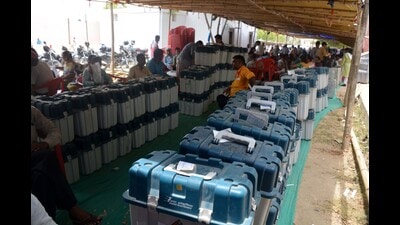 Polling officials collect EVMs and other election materials before leaving for their respective polling booths on the eve of the last phase of the Lok Sabha polls, in Varanasi police lines on Friday. (Rajesh Kumar/ht)