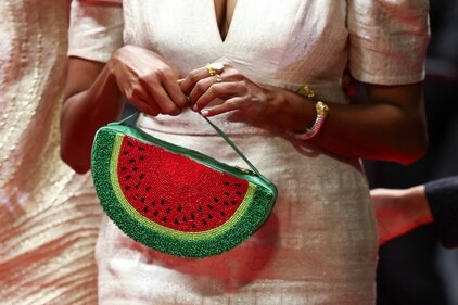 Kani Kusruti holds a watermelon bag on the red carpet, during arrivals for the screening of the film All We Imagine as Light at the Cannes Film Festival. (REUTERS/Sarah Meyssonnier)