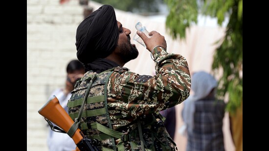 A paramilitary soldier on duty drinks water on a scorching afternoon as polling officials leave for their respective polling stations from an election material collection centre on the eve of the seventh and last phase of the Lok Sabha elections, in Amritsar on Friday. (ANI)