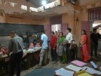 Lok Sabha election: Voters queue up to cast their ballots at a polling station during voting in Maharashtra
