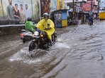 Kochi: Commuters wade through a flooded road amid rains, in Kochi Kochi: Commuters wade through a flooded road amid rains, in Kochi