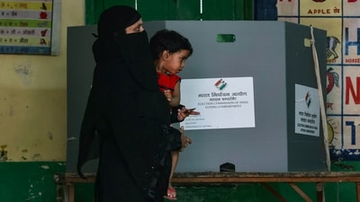 A woman carrying a child leaves the polling booth after voting in Varanasi, Uttar Pradesh. (Niharika Kulkarni / AFP) A woman carrying a child leaves the polling booth after voting in Varanasi, Uttar Pradesh. (Niharika Kulkarni / AFP)
